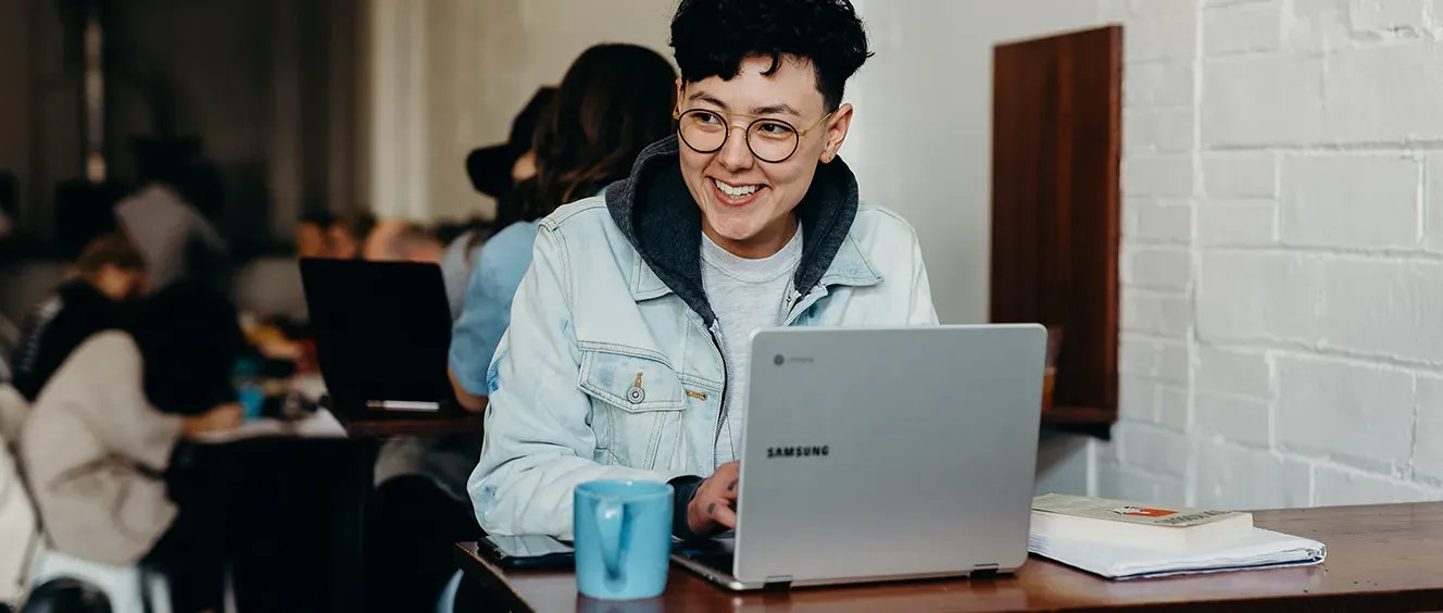 Woman on laptop smiling