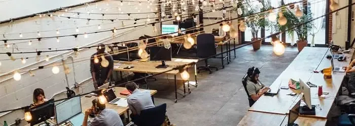 Lighting in a business office with workers in the background