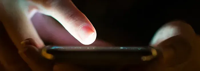 Person scrolling on mobile phone with right hand