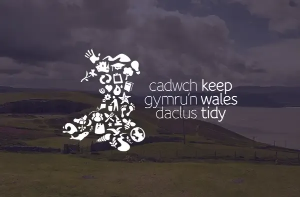 Keep Wales Tidy logo over an image of picturesque rolling hills