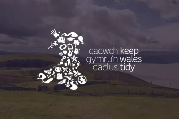 Keep Wales Tidy logo over an image of picturesque rolling hills