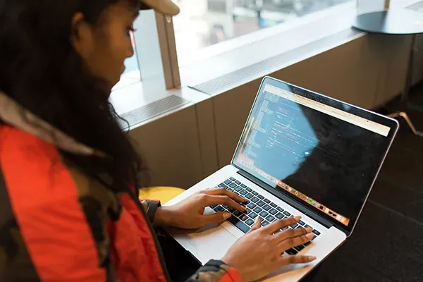 Woman coding on laptop