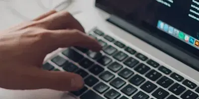 Person typing on Apple macbook