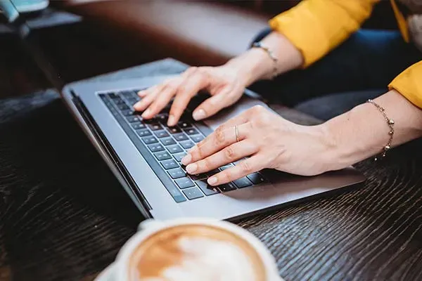 Woman using a laptop in a coffee shop