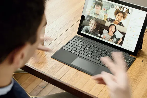 Man looking at laptop on a video call