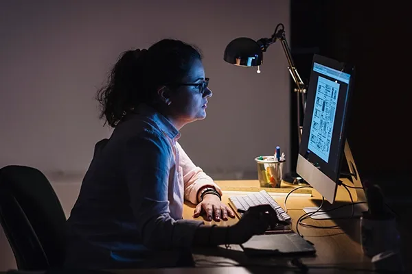 Woman looking intently at computer monitor