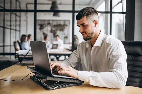 Man typing on laptop in office