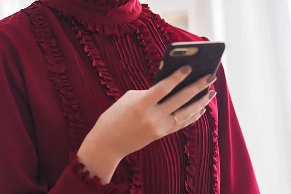 Woman in red dress looking at mobile phone