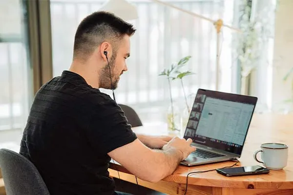 Man making a call on a laptop using the 3cx phone system