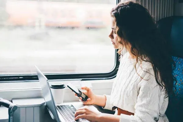 Woman using devices on train
