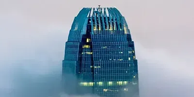 Glass skyscraper towering above the clouds