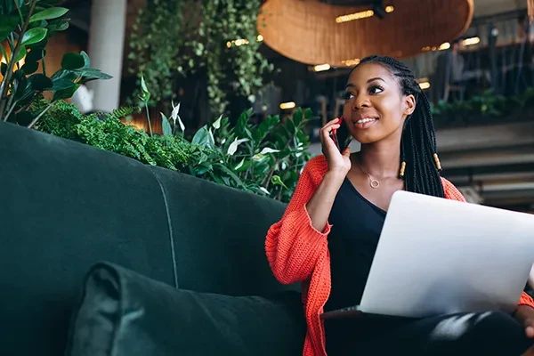 Woman talking to IT support technician at work