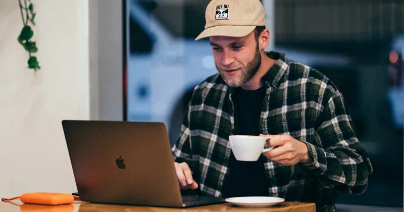 Person working at a table in a cafe