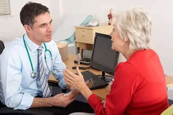 Male doctor speaking to female patient