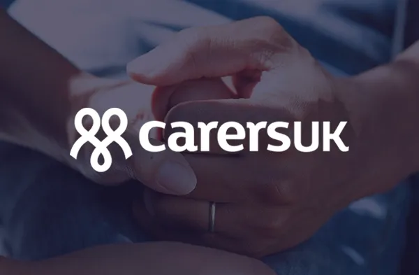 Person holding someone's hand with Carers UK logo overlaid