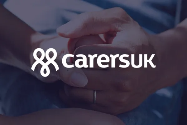 Person holding someone's hand with Carers UK logo overlaid