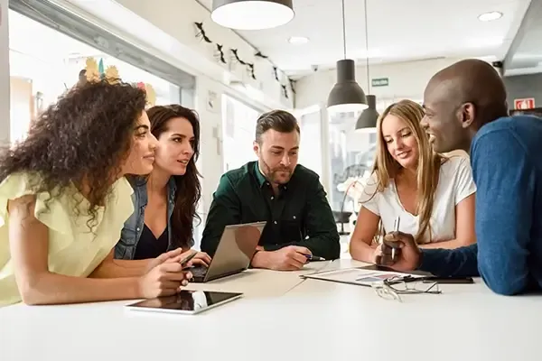 Group of people looking at each other around a table