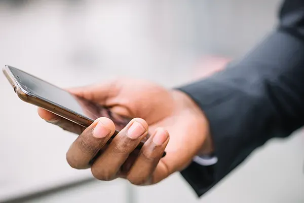 Man holding phone out in front of them