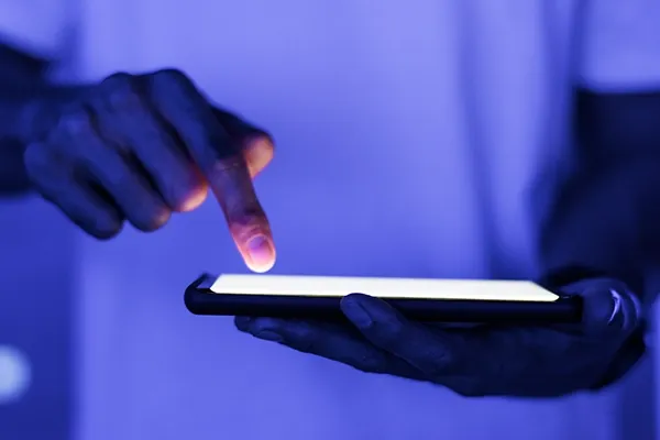 Person using tablet while holding out in front