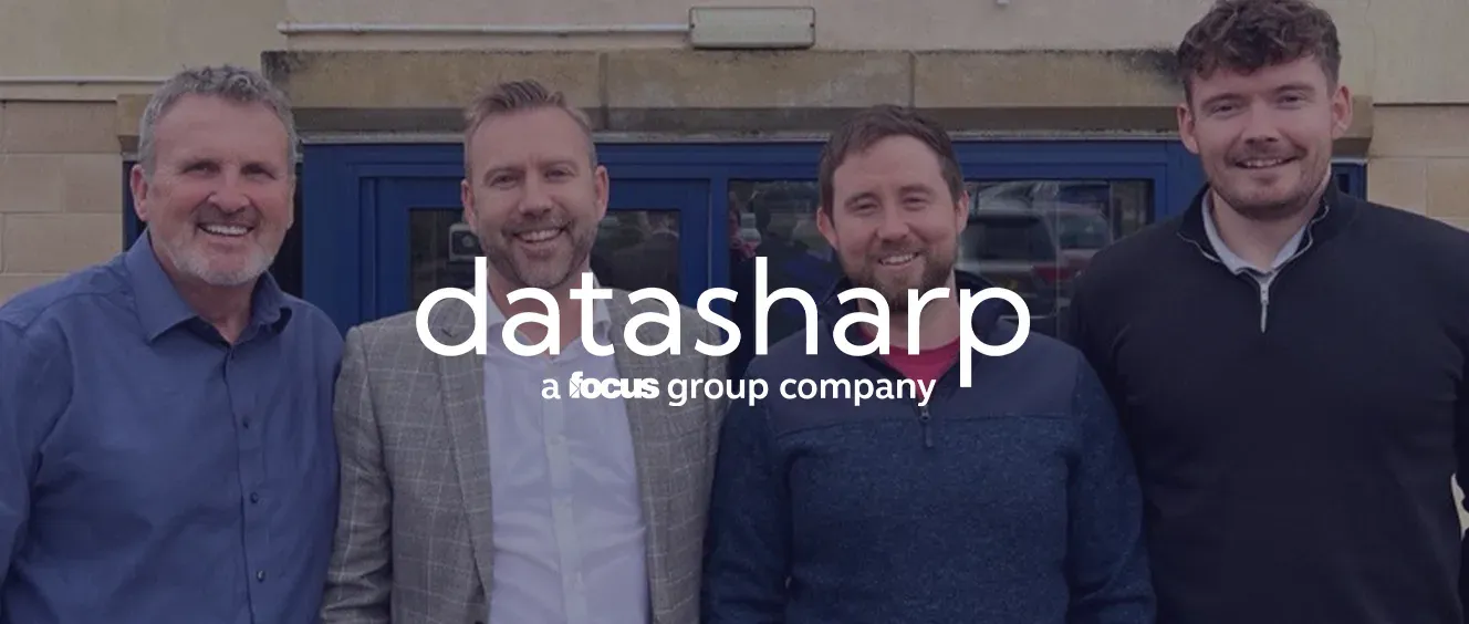 Four men smiling for the camera with the Datasharp logo overlayed