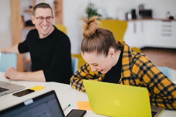 Woman talking to IT support technician at work