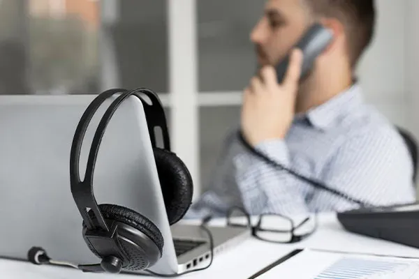 Man making a SIP trunk call from an office phone