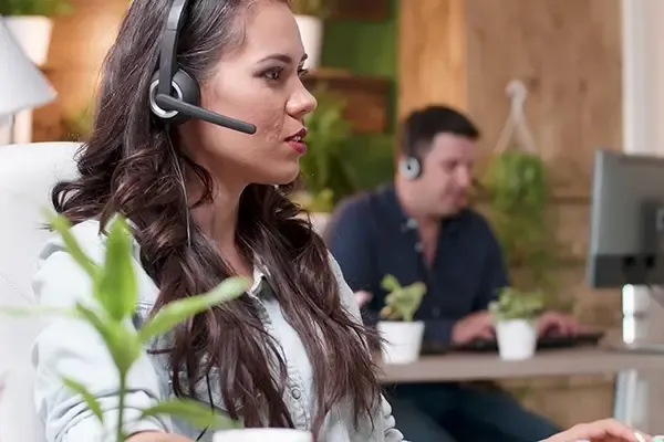 Woman talking with headset over head