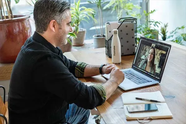 Man answering SIP call to a woman on his laptop