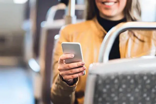 Woman looking at phone on bus