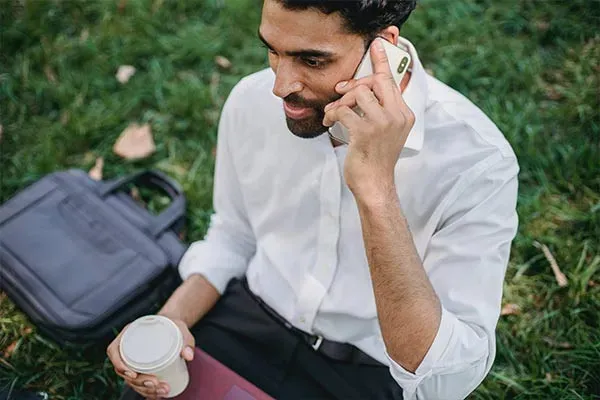 Business man using mobile phone in a park
