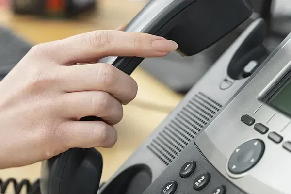 Close up of woman putting telephone down