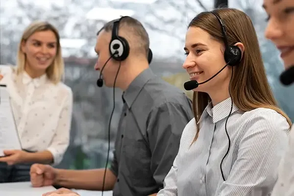 People sitting down talking with headset on