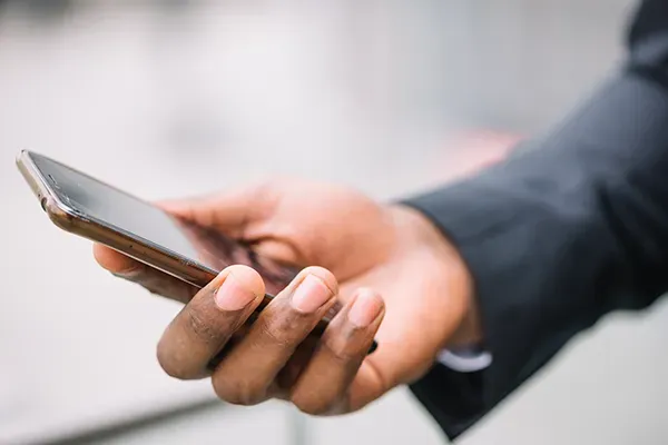 Man holding smartphone out in hand