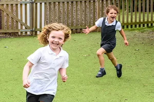 Two children running outside