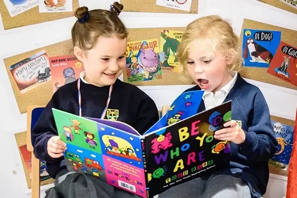 Two children reading a book