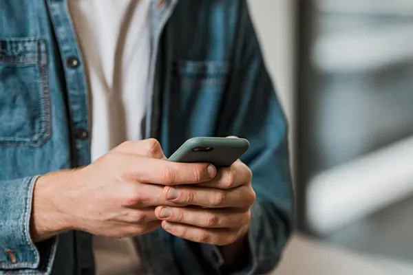 Person holding mobile phone in front of them