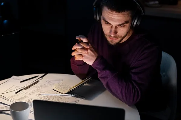 Man with headphones on looking at laptop
