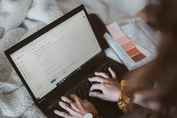 Woman sending an email on laptop