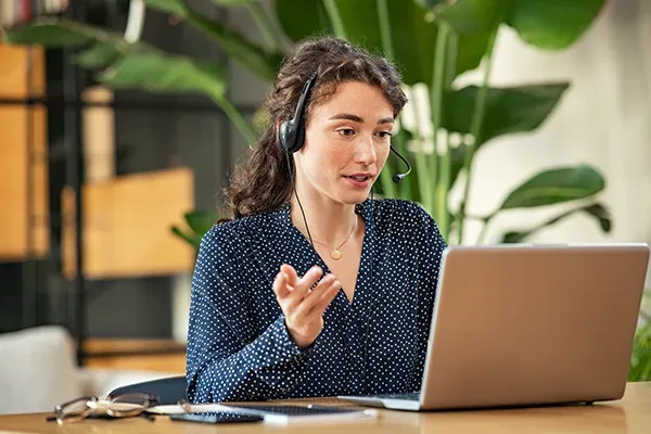 Woman with headphones on laptop