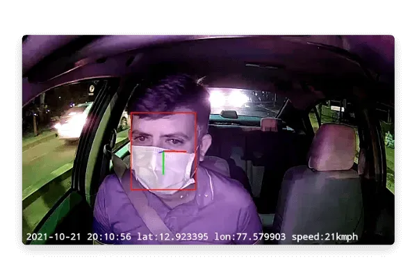 Dashcam facing inside car at a man with face mask