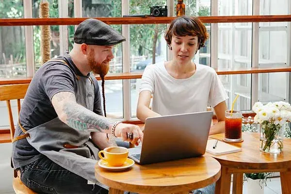 Man pointing at screen on laptop