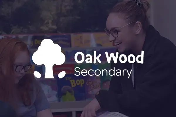 Oak Wood Secondary logo over an image of a teacher helping a student