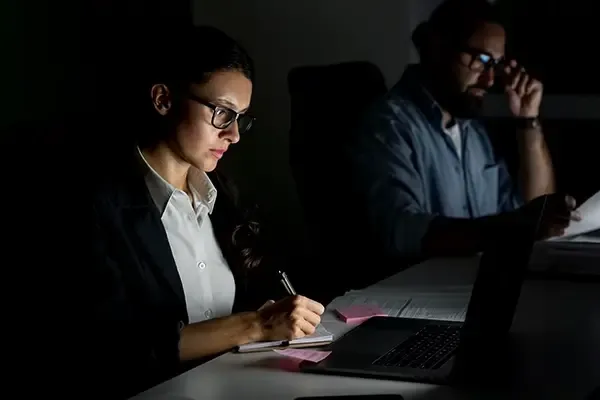 Woman with glasses writing notes