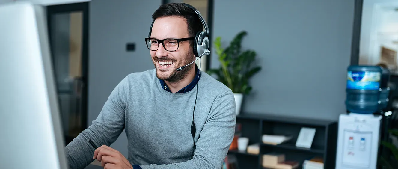 Man with glasses and headset on smiling
