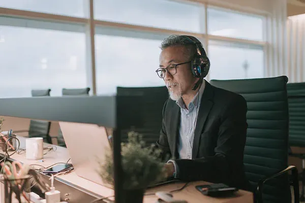 Man in an office using a headset connected to an on premise business phone system