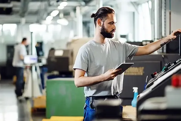 Man in factory looking at equipment