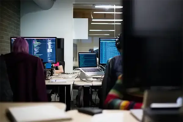 Developers sat at desk in office