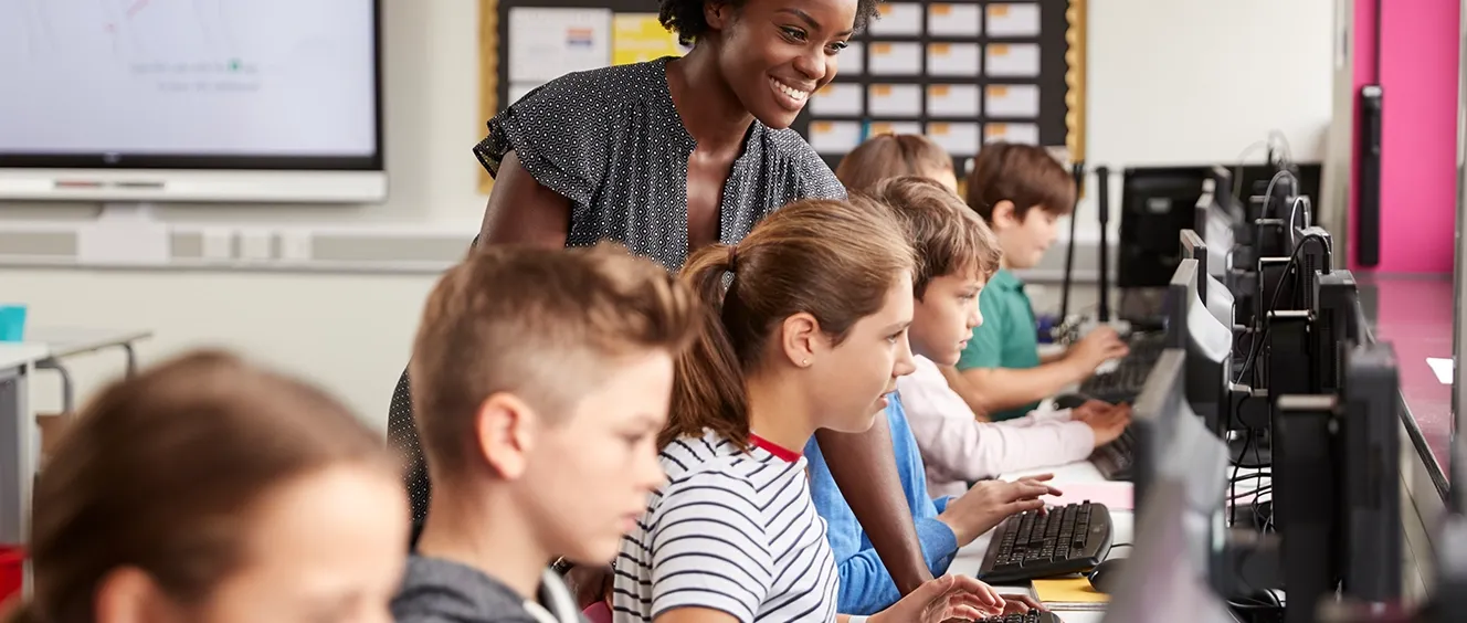 School children looking at computer monitors
