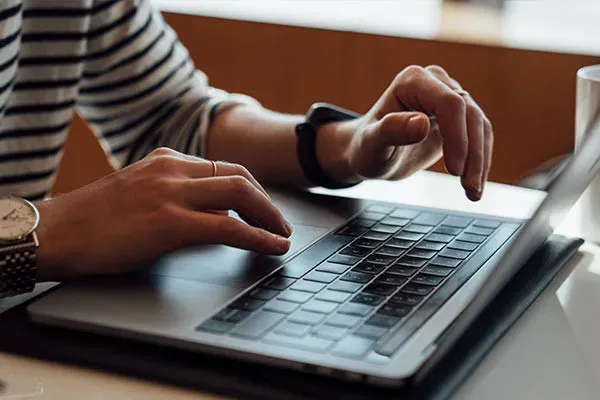 Woman managing SIP trunk calls from a laptop