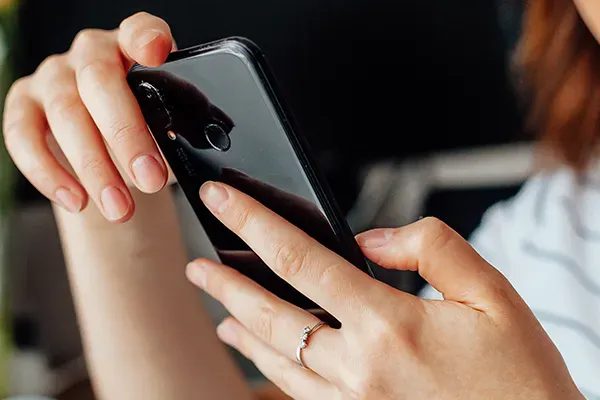 Woman looking at phone in their hands